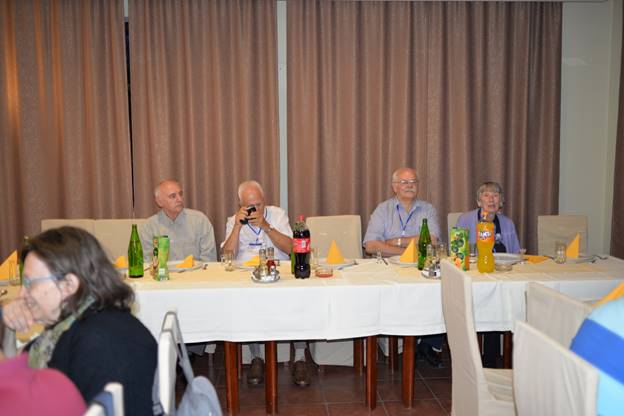 A group of people sitting at a table

Description generated with very high confidence