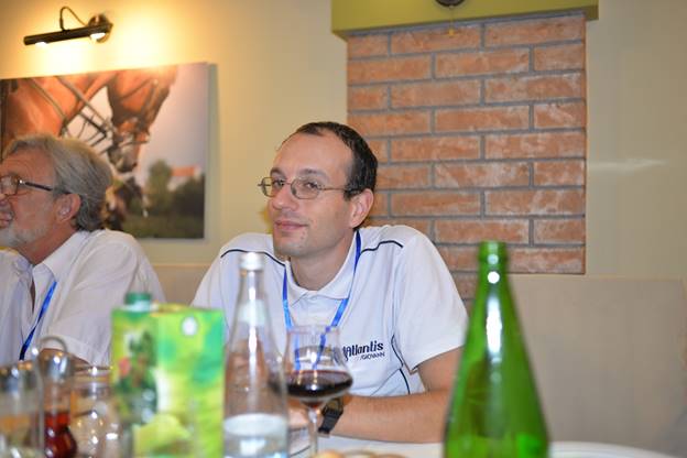 A group of people sitting at a table with wine glasses

Description generated with very high confidence