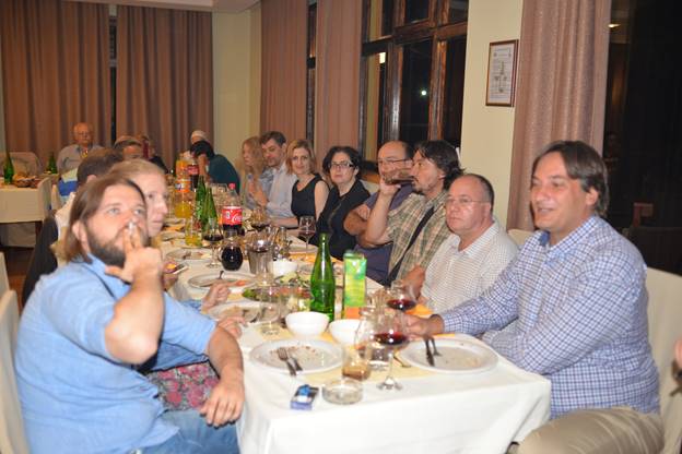 A group of people sitting at a dinner table

Description generated with very high confidence