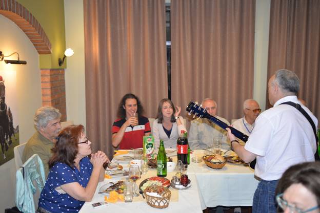 A group of people sitting at a table with wine glasses

Description generated with very high confidence