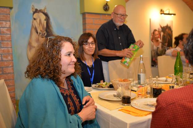 A group of people sitting at a table

Description generated with very high confidence