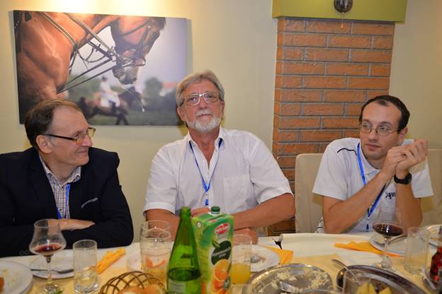 A group of people sitting at a table with food

Description generated with very high confidence