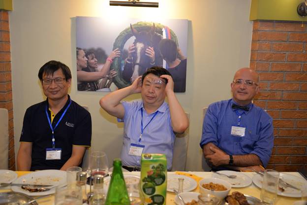 A group of people sitting at a table eating food

Description generated with very high confidence