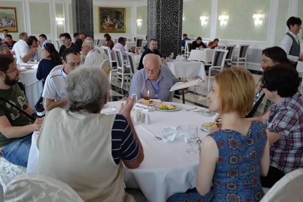 A group of people sitting at a table

Description generated with very high confidence