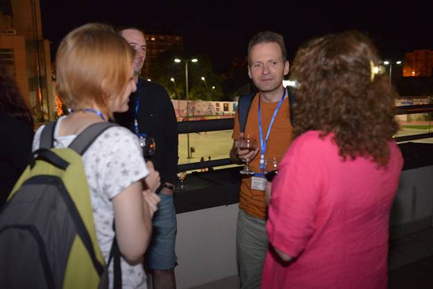 A group of people looking at a cell phone

Description generated with very high confidence