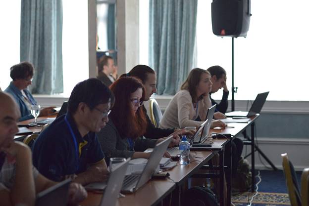 A group of people sitting at a table

Description generated with very high confidence