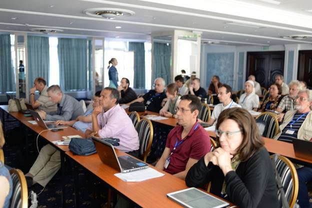 A group of people sitting at a table using a computer

Description generated with very high confidence