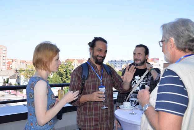 A group of people looking at a cell phone

Description generated with high confidence