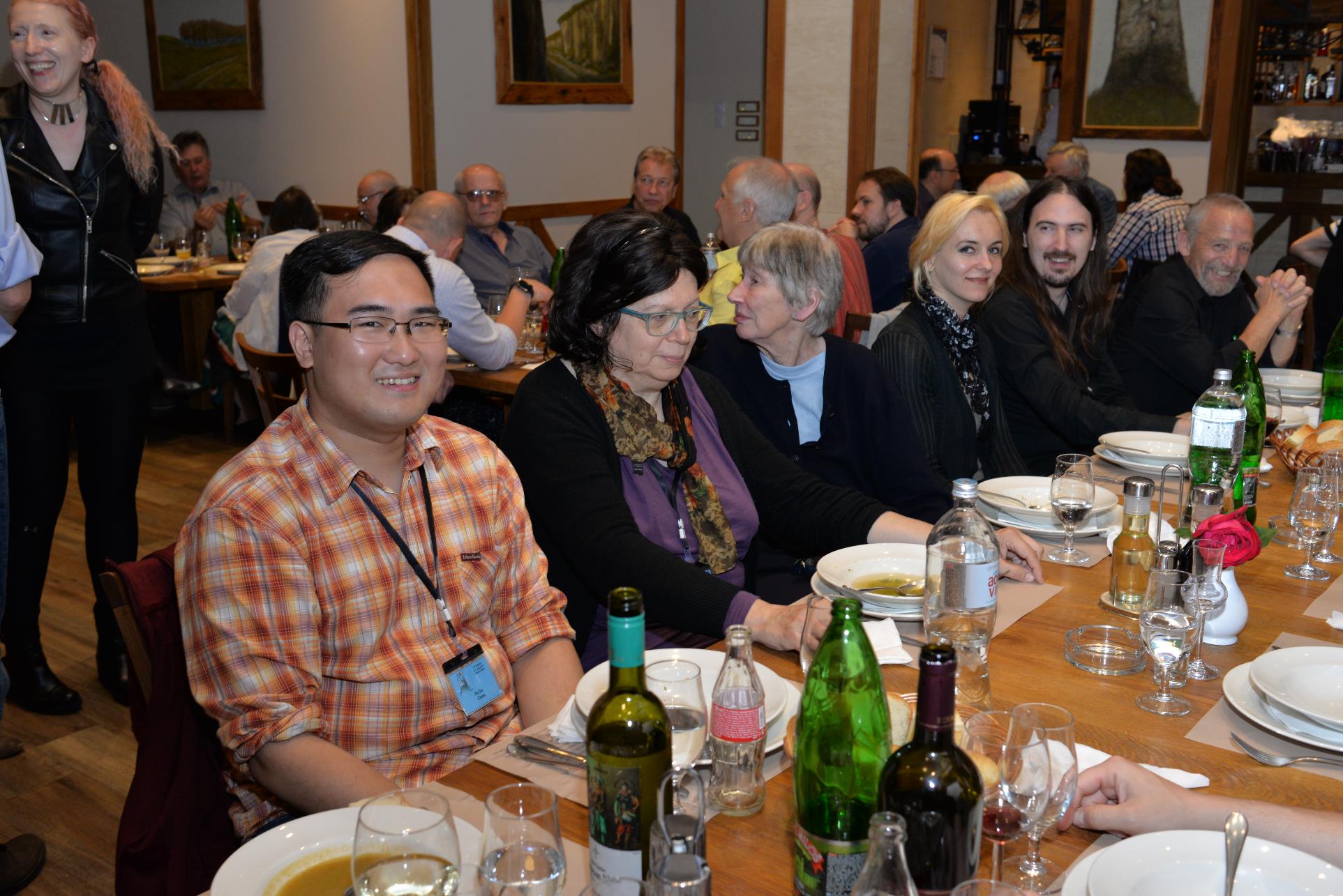 A group of people sitting at a table with wine glasses

Description automatically generated