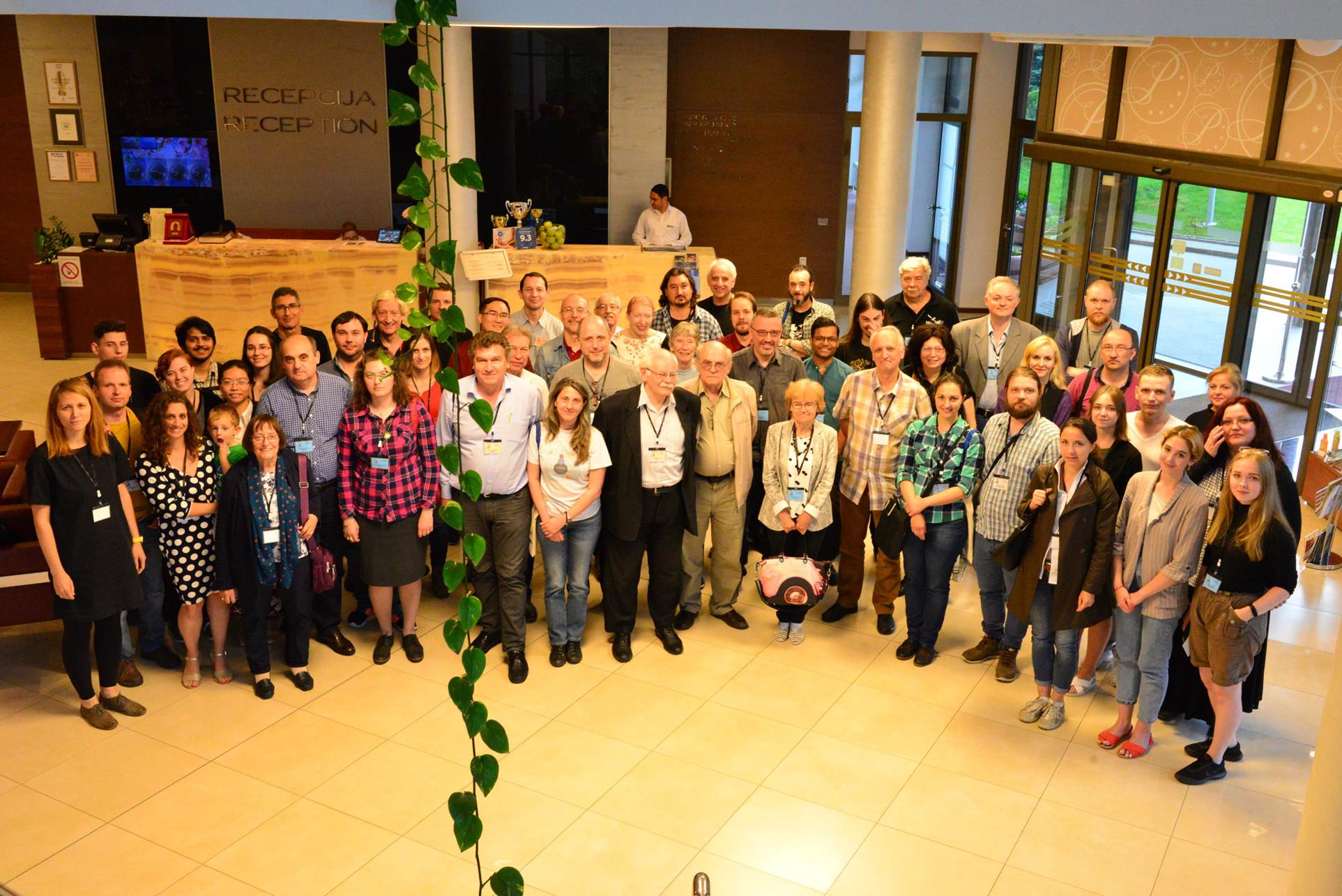 A group of people standing in front of a crowd posing for the camera

Description automatically generated