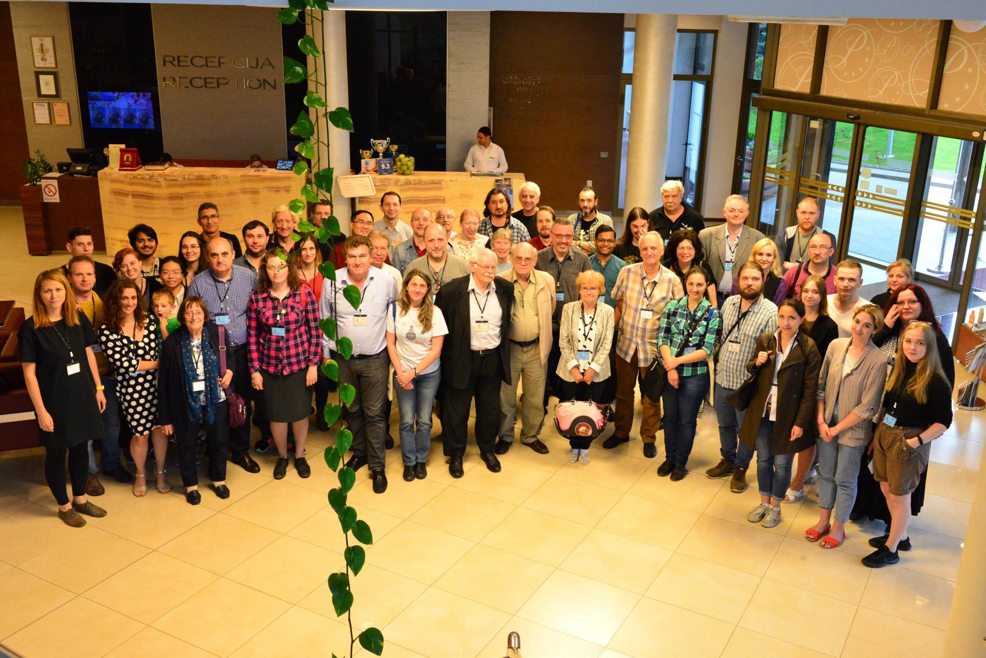 A group of people standing in front of a crowd posing for the camera

Description automatically generated