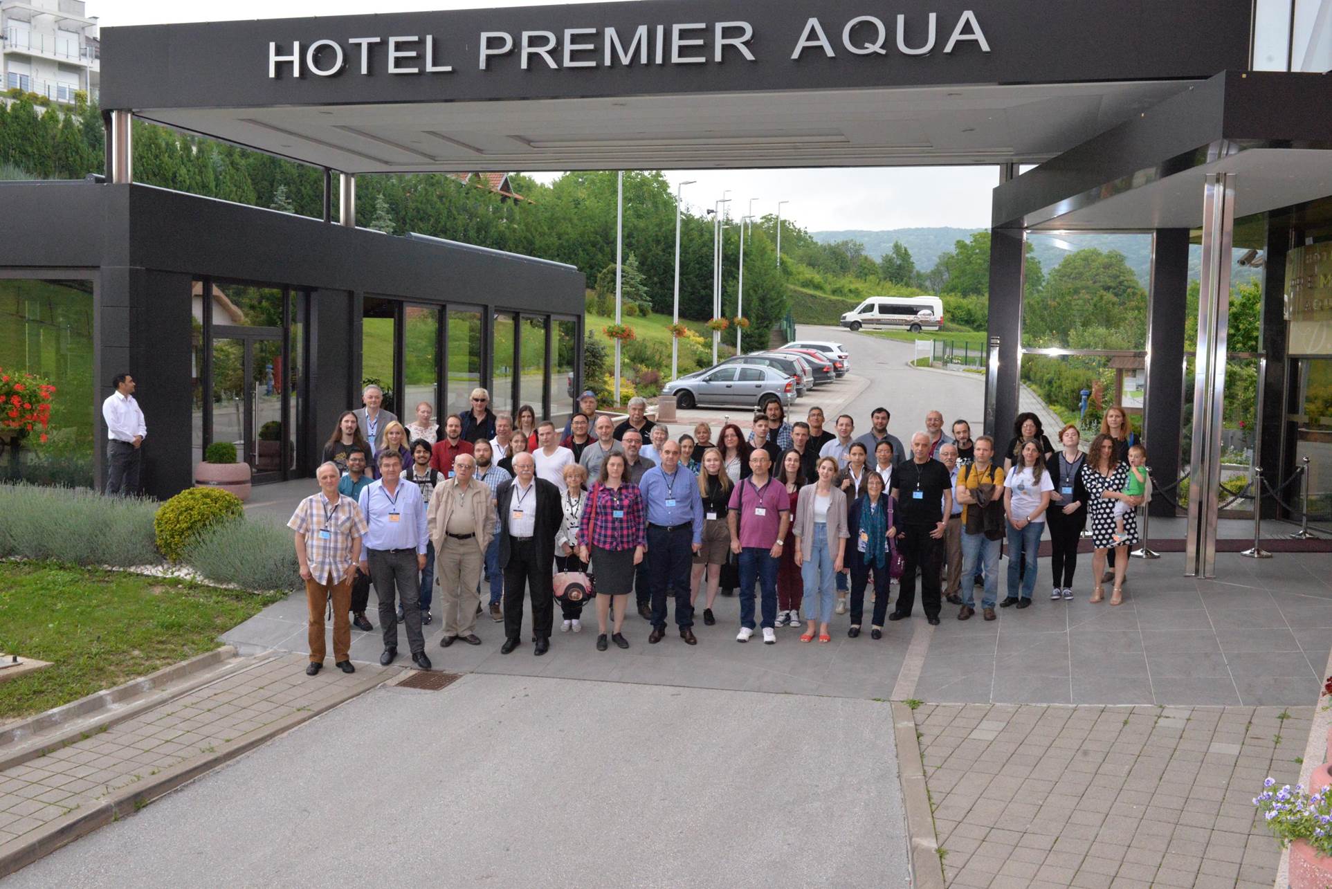 A group of people standing in front of a building

Description automatically generated