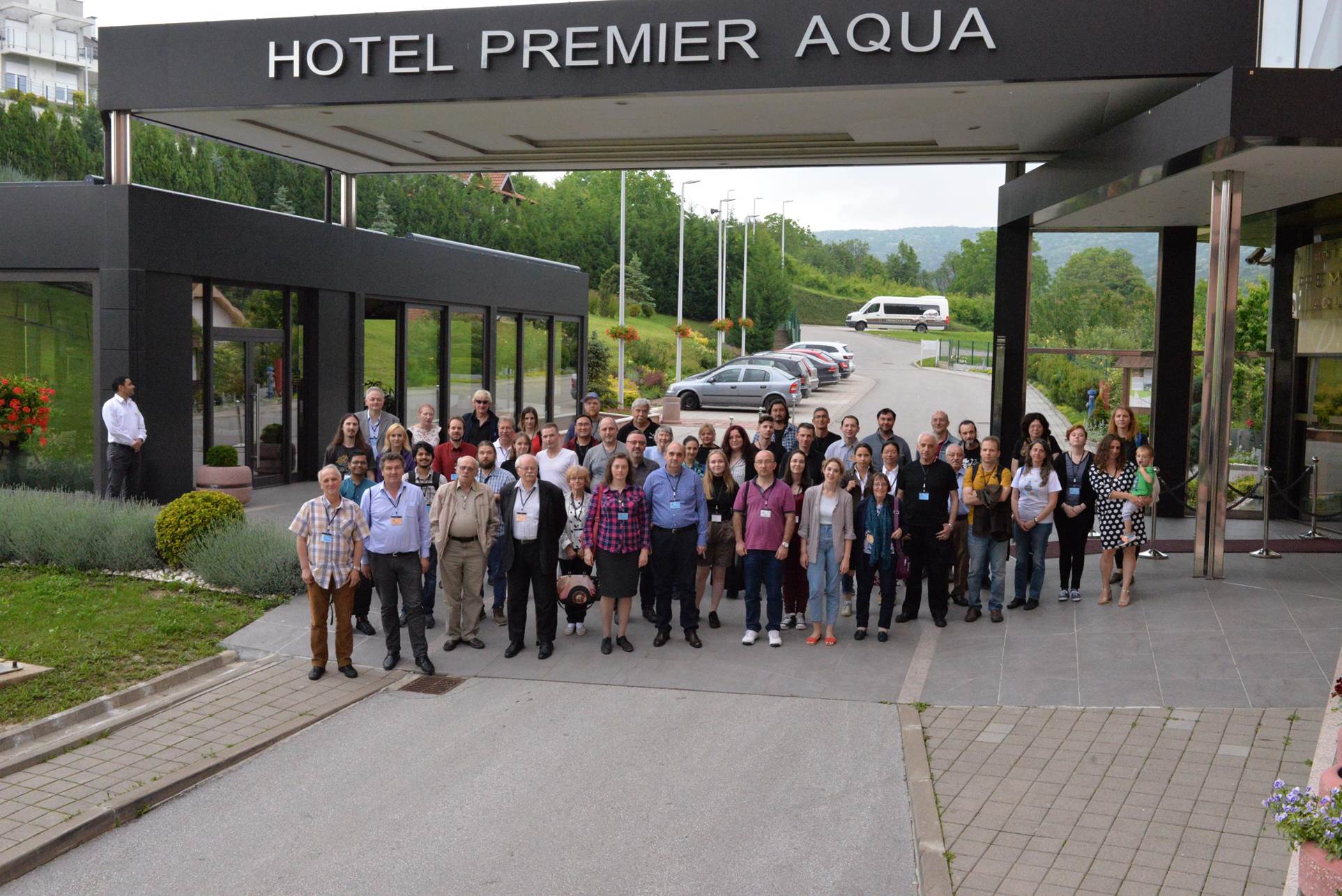 A group of people standing outside of a building

Description automatically generated