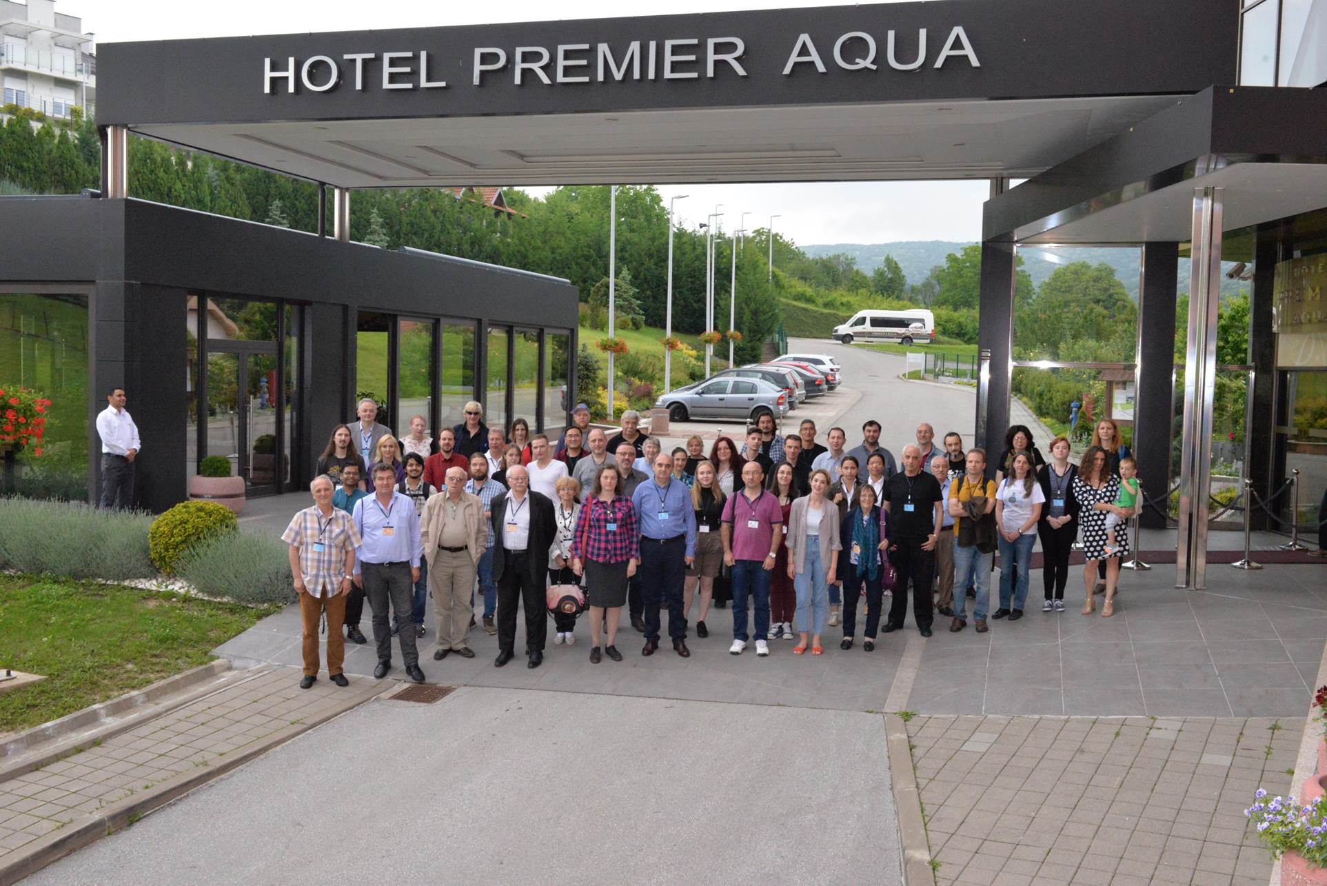 A group of people standing in front of a building

Description automatically generated