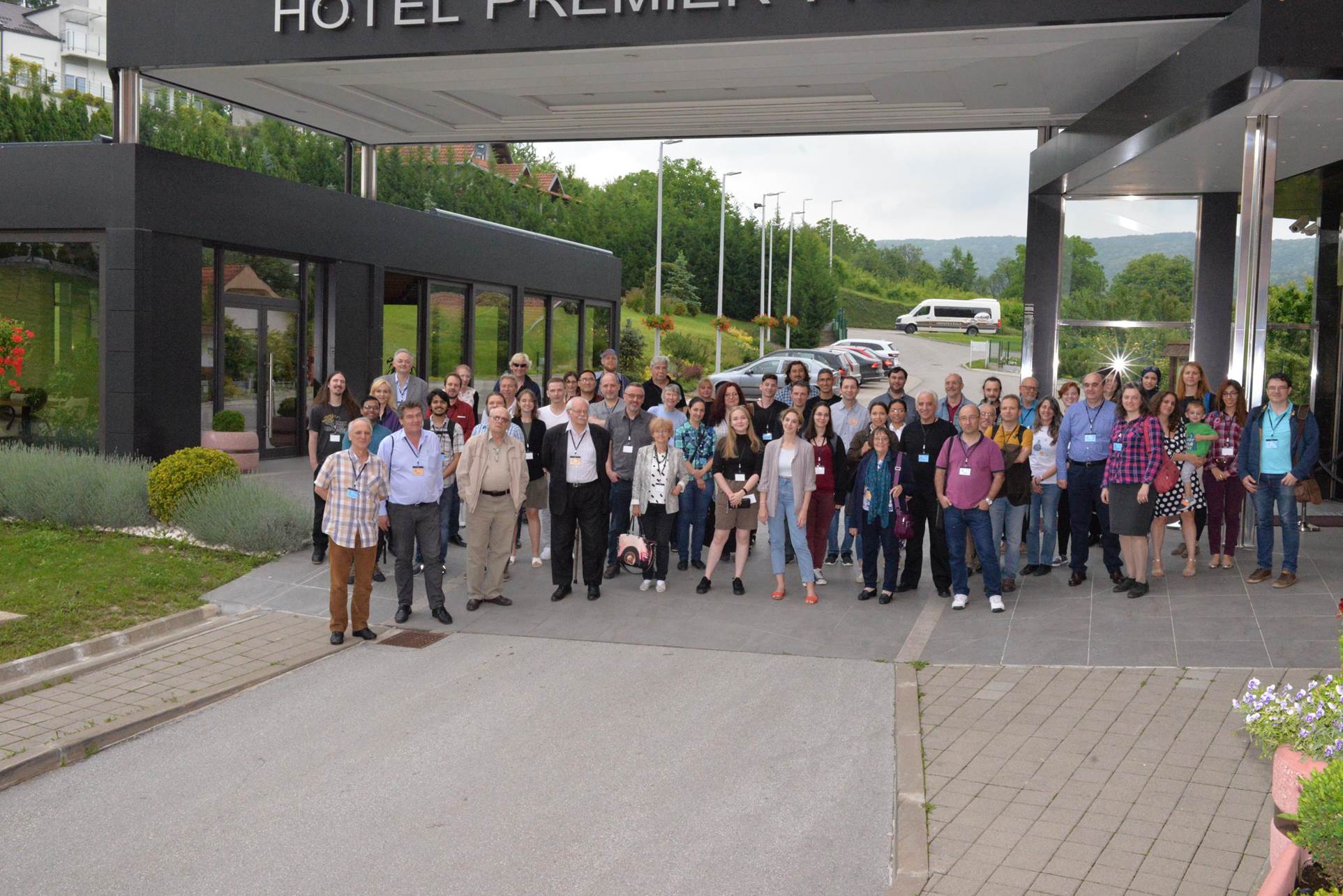 A group of people standing in front of a building

Description automatically generated