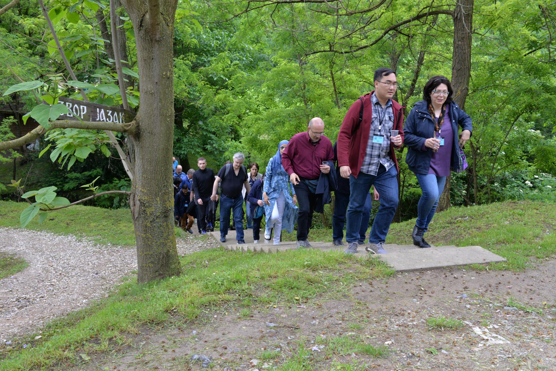 A group of people standing next to a tree

Description automatically generated