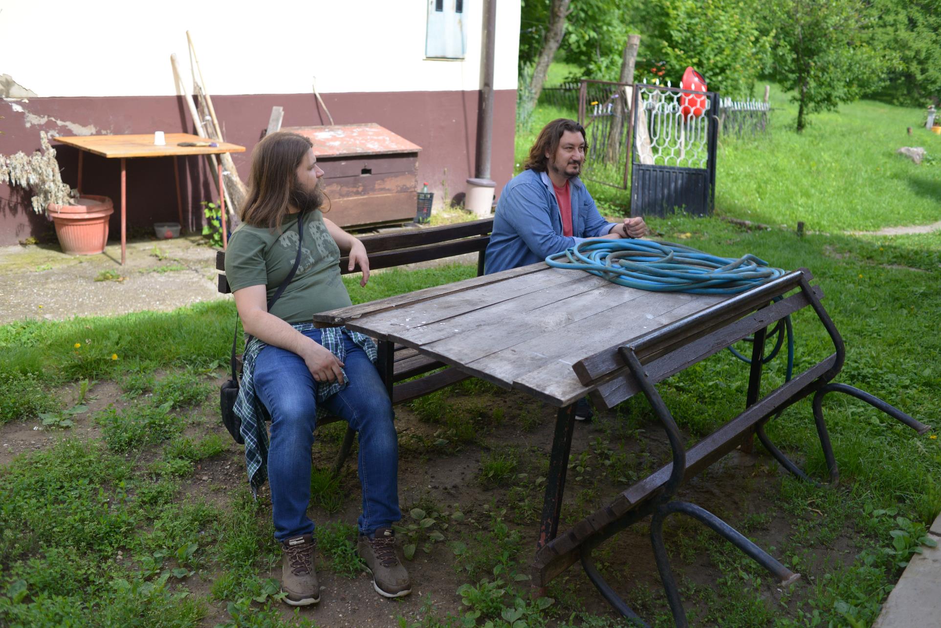 A person sitting at a picnic table

Description automatically generated