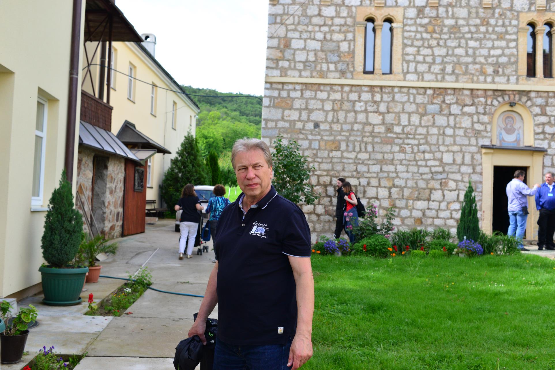 A person standing in front of a building

Description automatically generated