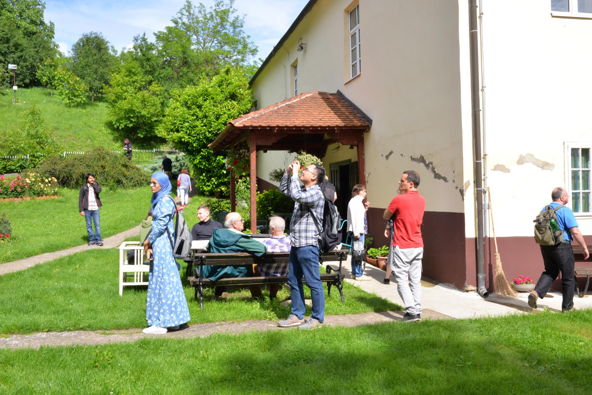 A group of people that are standing in the grass

Description automatically generated