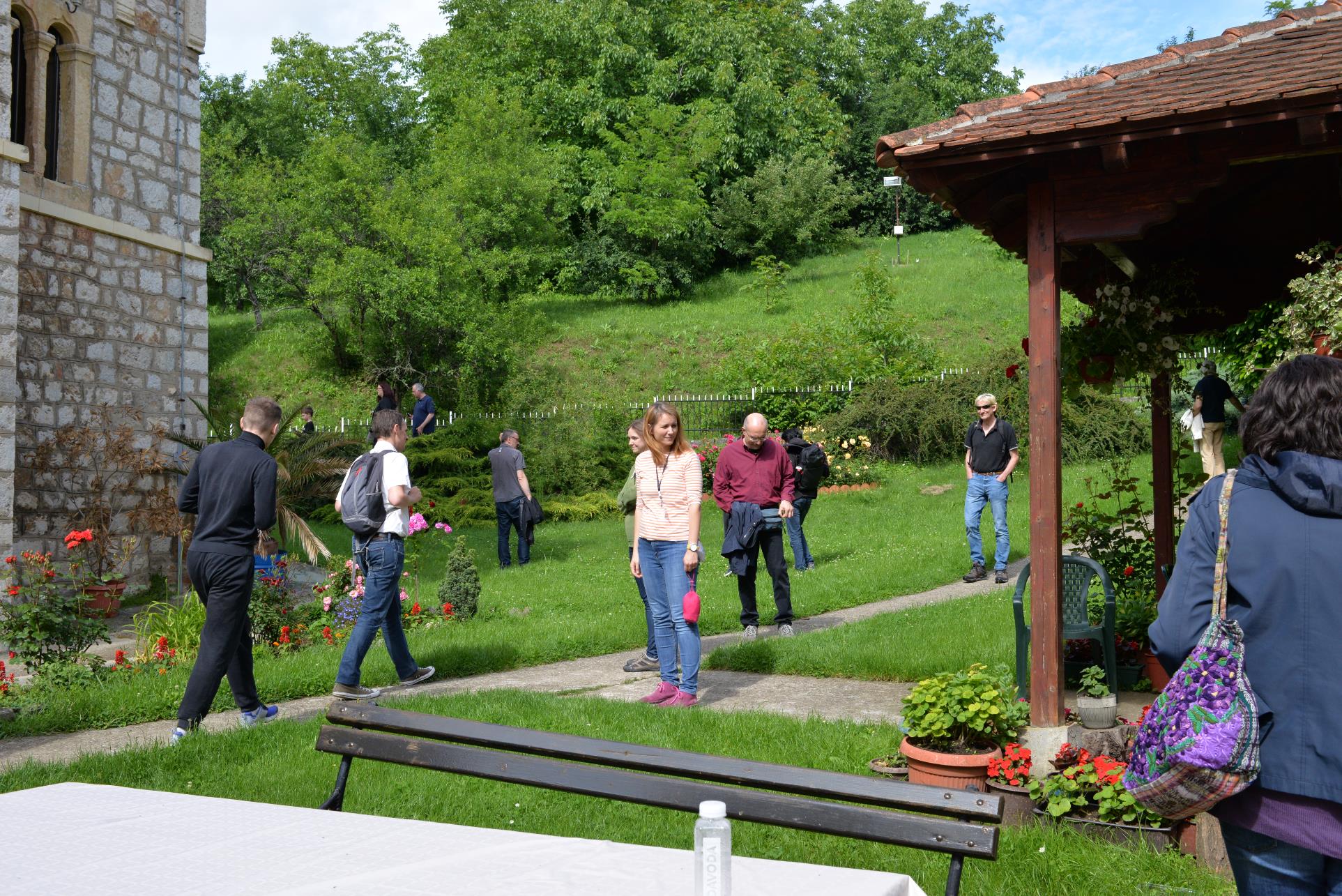 A group of people standing in a yard

Description automatically generated