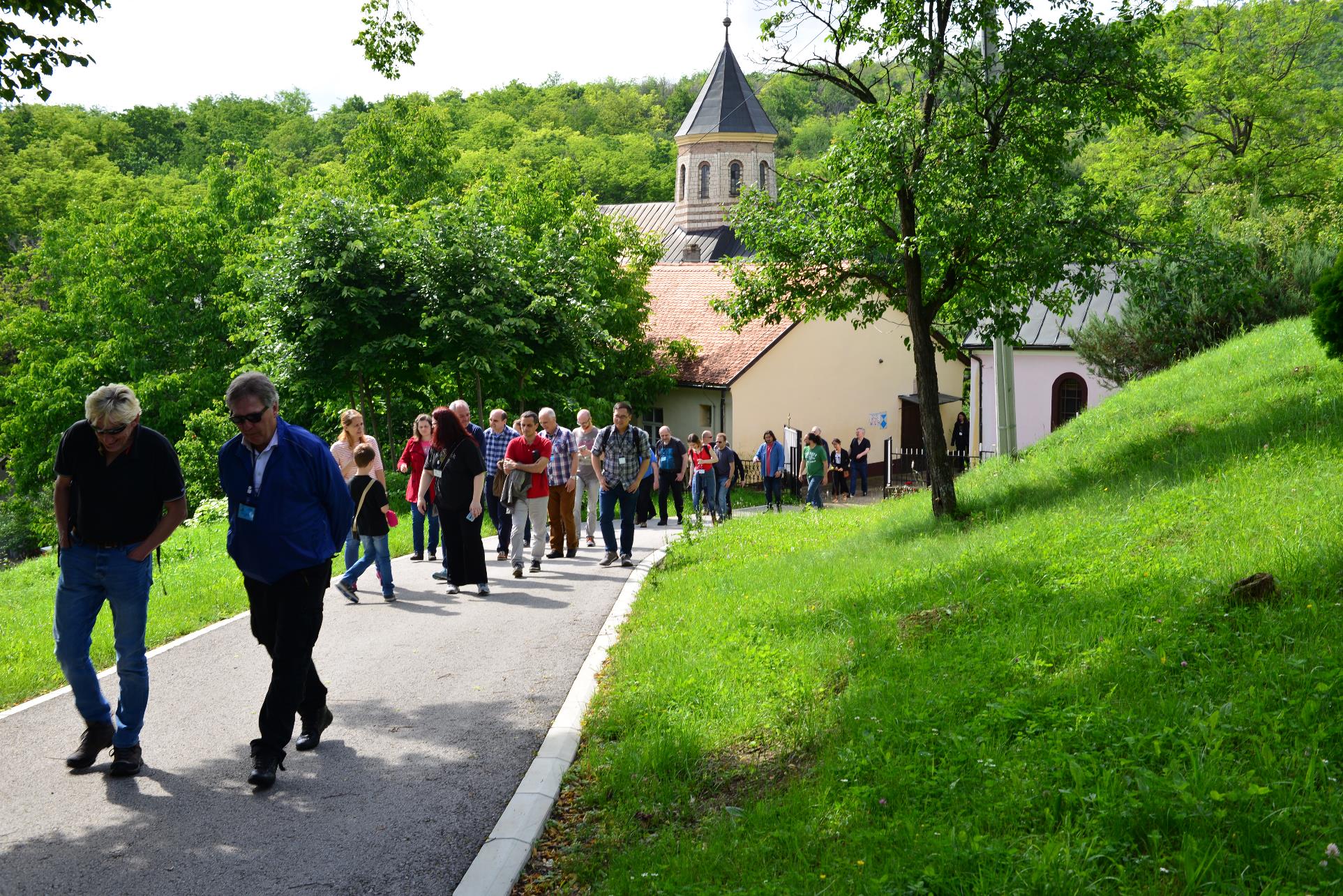 A group of people walking on a path

Description automatically generated