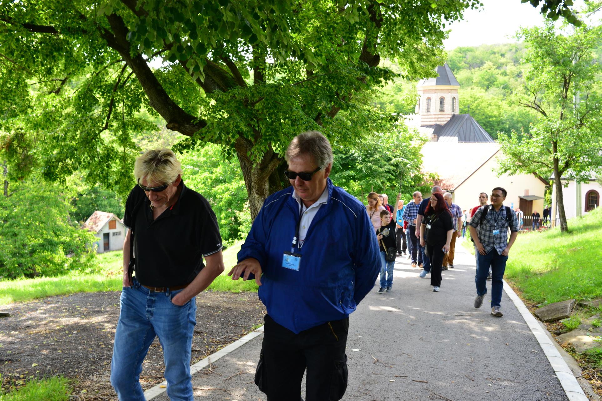 A group of people standing next to a tree

Description automatically generated