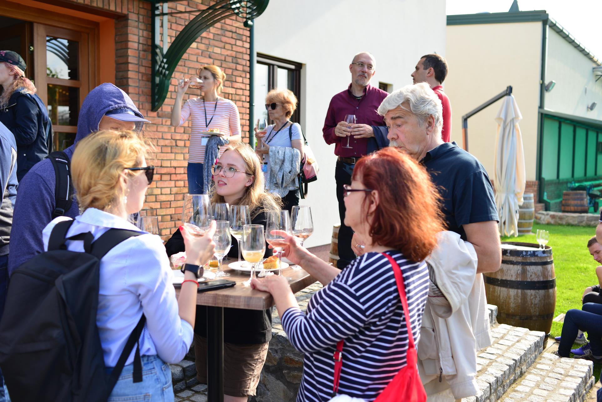 A group of people holding wine glasses

Description automatically generated