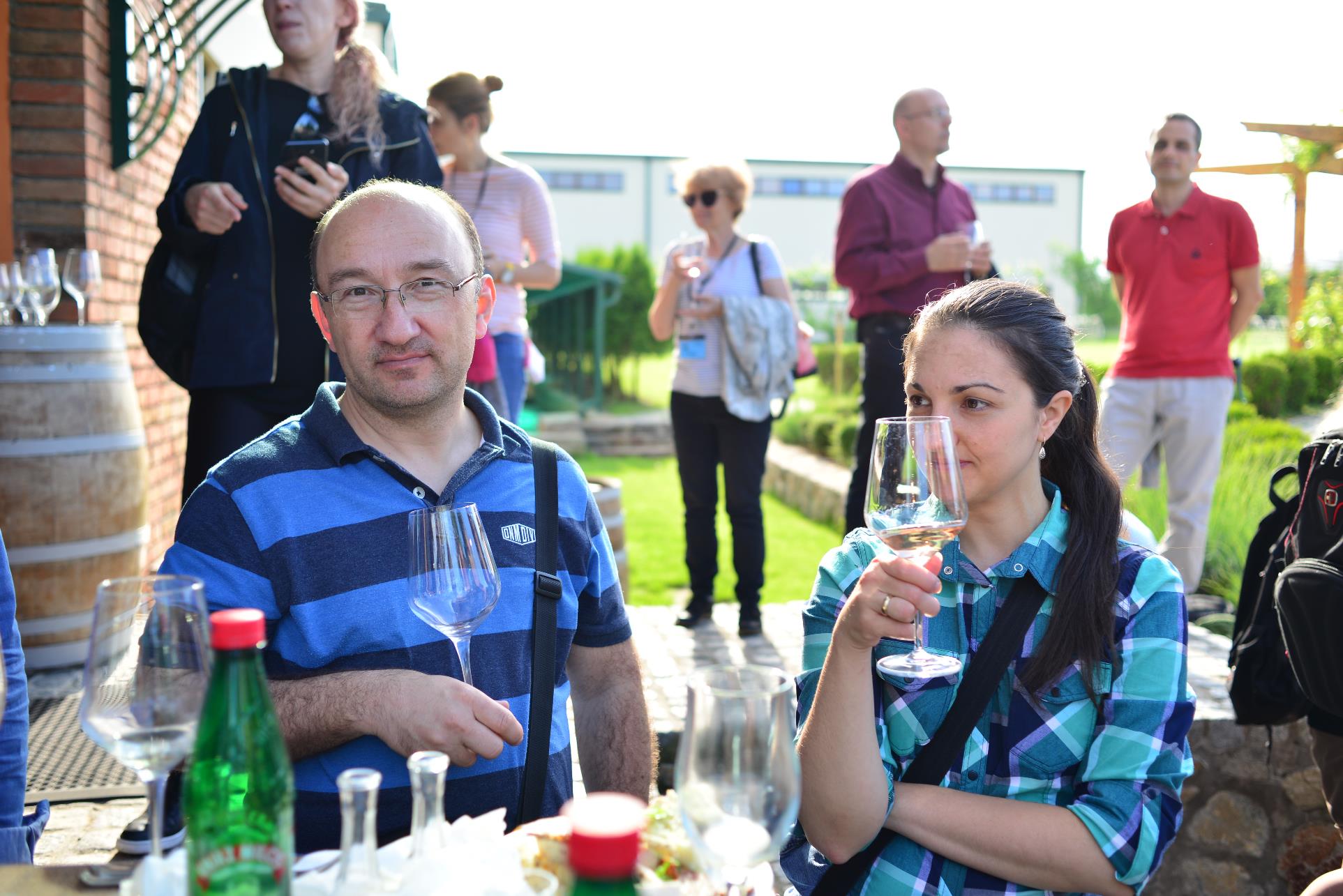 A group of people sitting at a table with wine glasses

Description automatically generated