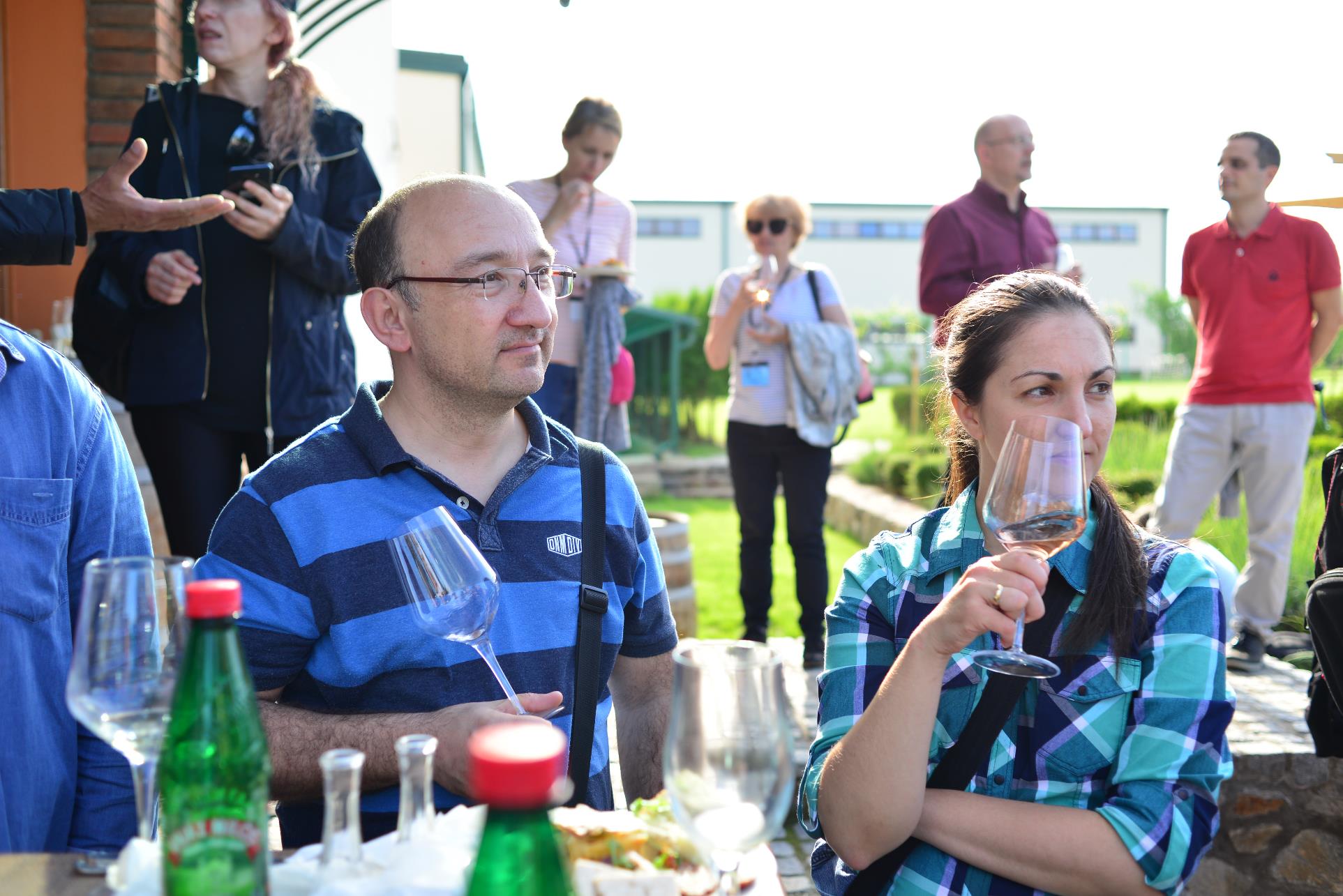 A group of people sitting at a table drinking wine

Description automatically generated