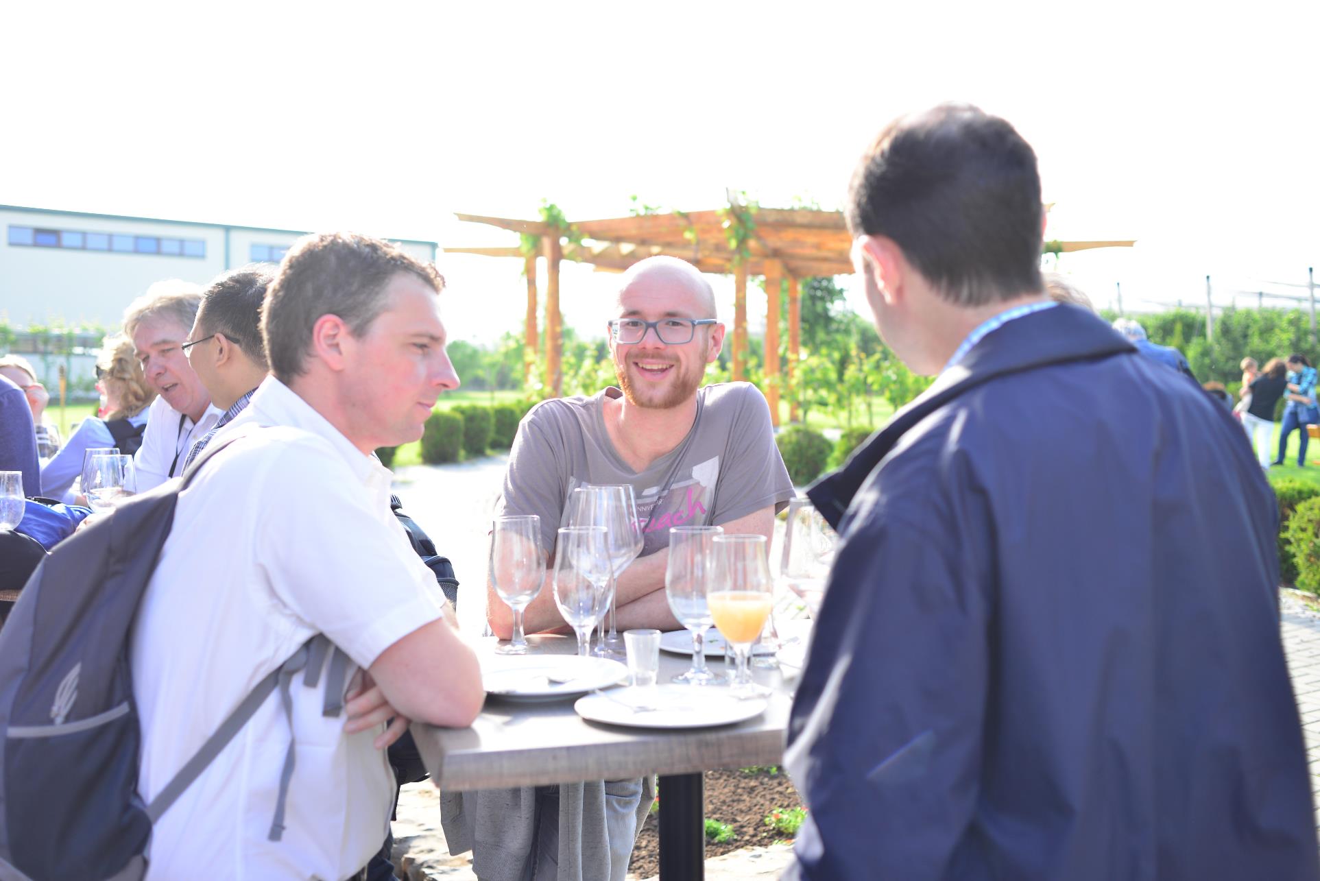 A group of people standing around a table

Description automatically generated