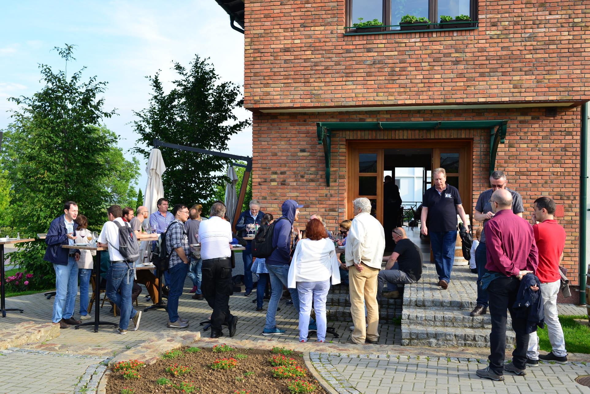 A group of people standing in front of a building

Description automatically generated