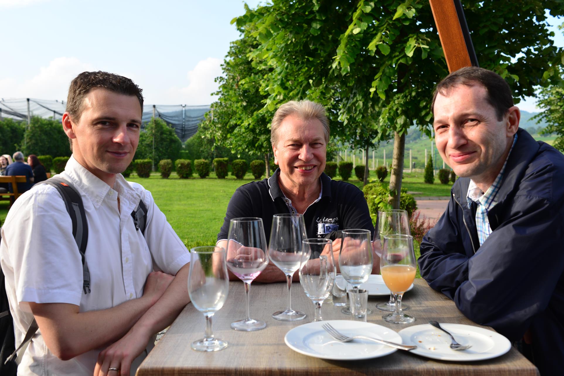 A group of people sitting at a table with wine glasses

Description automatically generated